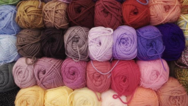 Wall of alpaca, baby alpaca and sheep wool exhibit in a Bolivian market	