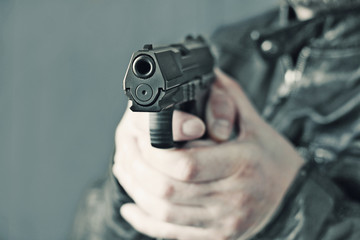 man with hand gun pistol rubber attack violence