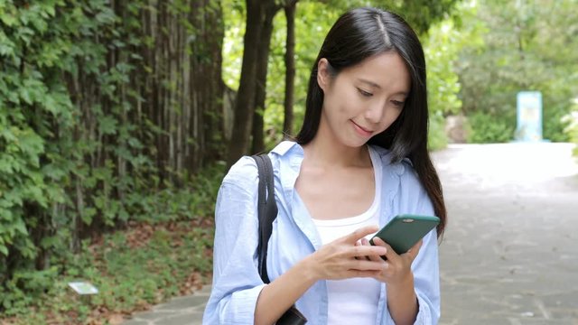 Woman use of mobile phone in the park