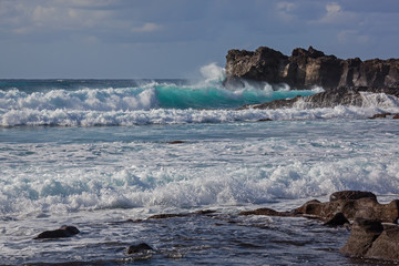 Majestic ocean waves crash against the black rocks of volcanic coastline of Atlantic ocean on Lanzarote island, Canary Islands, Spain