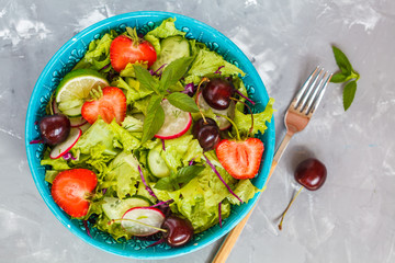 Bright summer salad of vegetables and berries. Love for a healthy vegan food concept.