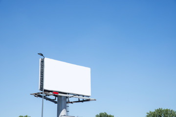 Empty billboard against a blue sky