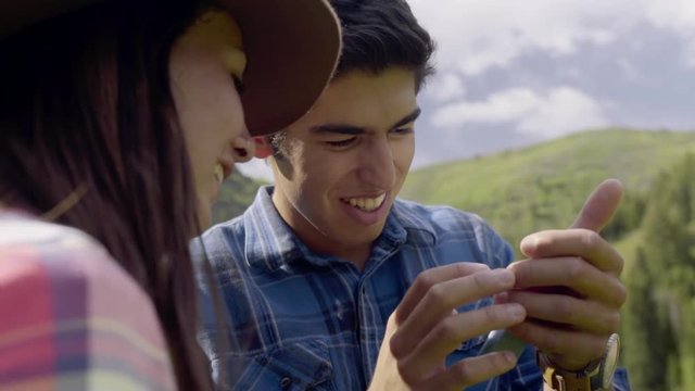 Teenager Shows Girlfriend Something On His Phone (Slow Motion)