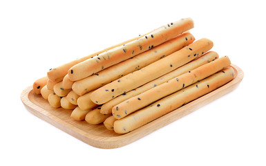 Black sesame biscuits in wooden plate isolated on white background