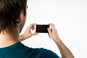 Young handsome man taking selfie on mobile phone camera
