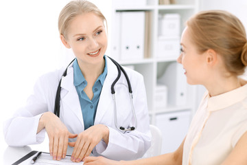Doctor and  patient  sitting at the desk 