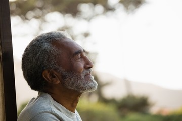 Senior man relaxing at the entrance of house