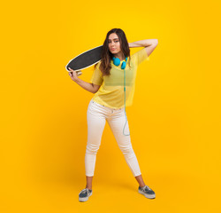 Fototapeta na wymiar Brunette teen with skateboard standing