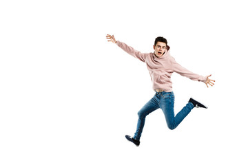 Fototapeta na wymiar Young man jumping on white background 