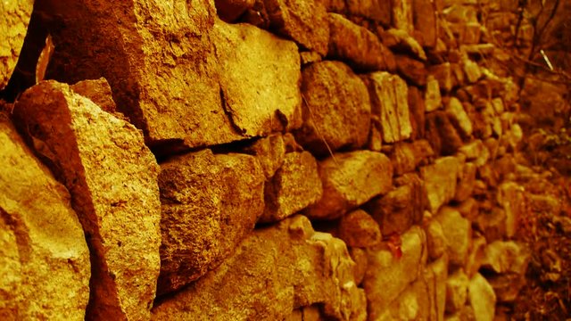 shine golden sunlight on stone wall,travelers back and winding lane in mountain.