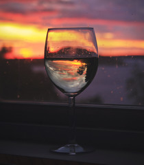 Beautiful summer season specific photograph. Wine glass silhouette. Sunset in the background. - 163011652