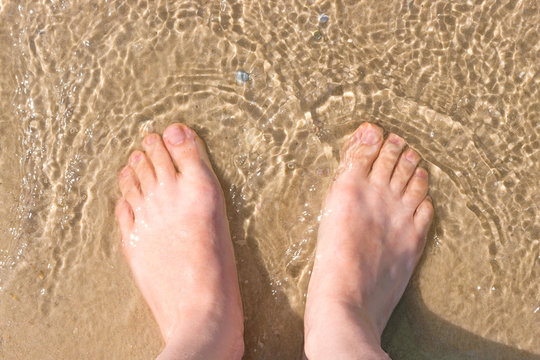 woman feet in the water, sea summer