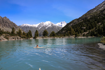 Fototapeta na wymiar Swimming in a mountain lake 
