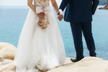 Obraz na płótnie Canvas feet of bride and groom, wedding shoes