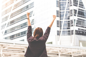 Successful professional businesswoman rise her arms up