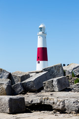 Portland Bill Lighthouse on Portland rocks in sunny summer day