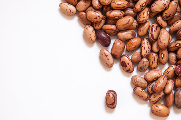 Dry brown beans on white background.