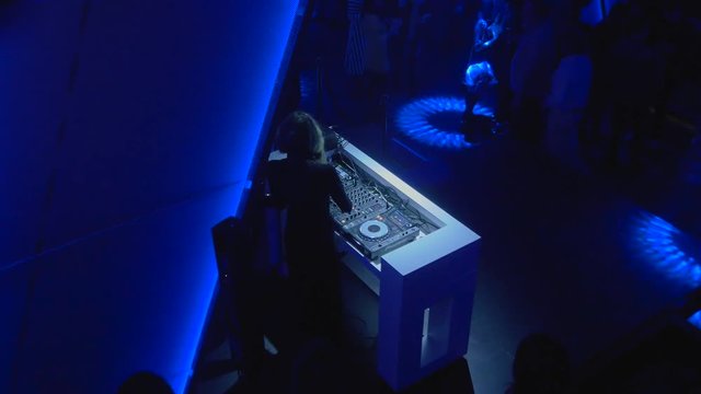 Dj booth in party in club with performance and ambient light blue and dark