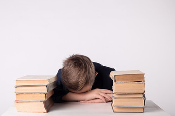 A child of primary school age do homework. The boy does his homework at his desk at home.
