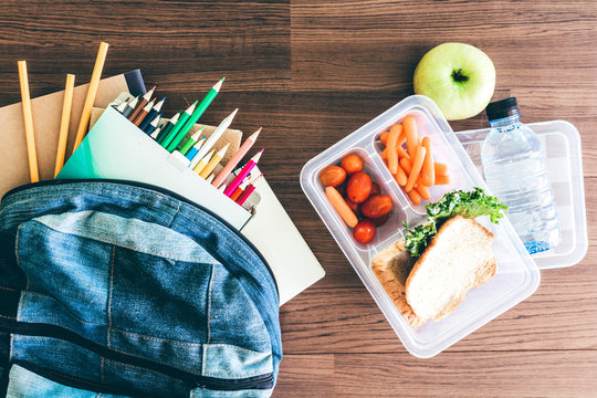 Lunch Box With Vegetables And Slice Of Bread For A Healthy School Lunch On Wooden Table