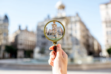 Holding a magnifying glass focused on famous Jacobins fountain in Lyon city in France