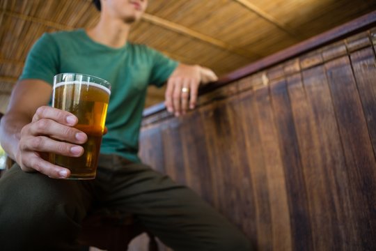Low angle view of man holding beer glass