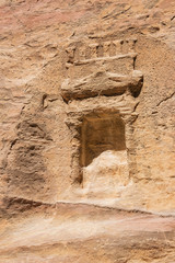 Idol niche in the Siq topped with a pediment, seen from the trail to Petra