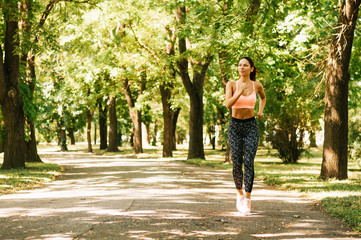 Young woman running outdoors in a city park