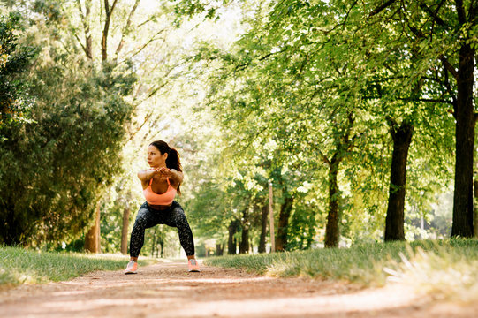 Beautiful woman working out in summer park