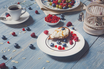 Breakfast with baked pea and berries at blue rustic wood