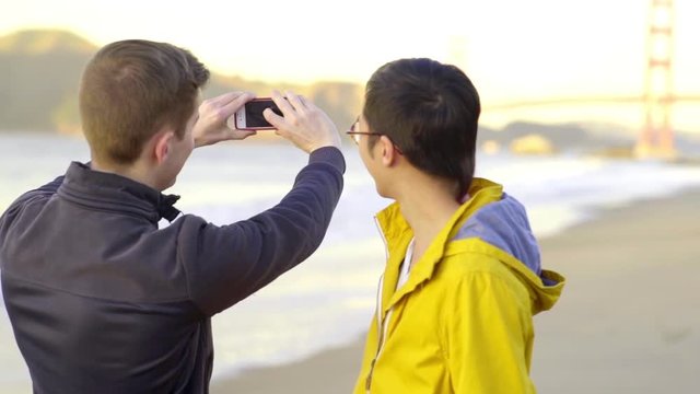 Mixed Race Gay Couple Stop To Take A Photo Of The Golden Gate Bridge 
