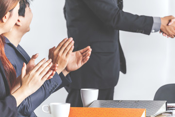 Business people clapping hands in the meeting