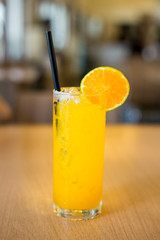 Fresh orange juice and ice in a glass.
