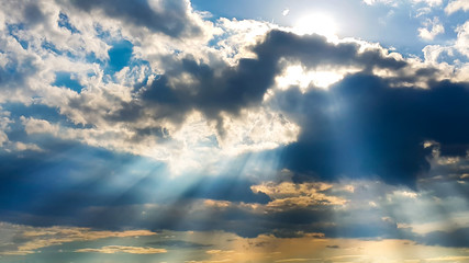Fototapeta na wymiar Sun light and sun rays with blue sky and clouds in rainy season above the horizon