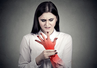 Woman holding her painful wrist