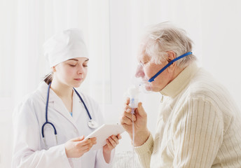 doctor does inhalation elderly man