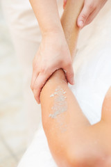 Woman Getting a Salt Scrub Beauty Treatment in the Health Spa