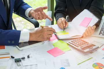 Business concept,Executives are instructing secretaries,The secretary is taking note of the executive order and on the desk there is a calculator with the document placed.