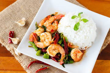 stir fri shrimp with basil leave on top cooked rice.thai style food.