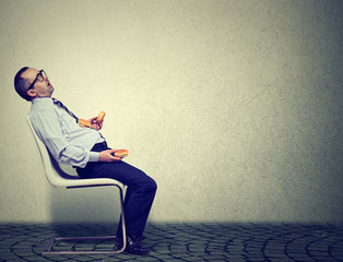 Business man feeling tired and sleepy after eating too many burgers for lunch