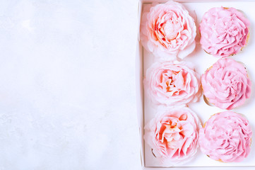 Pink cupcakes with roses in box. Festive and bright. Wedding Celebration concept.