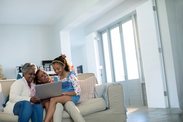 Happy family using laptop in living room