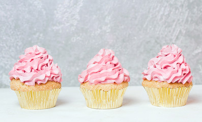 Pink cupcakes with roses and holiday cake. Festive and bright. Wedding Celebration concept.