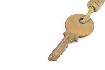 Old brass key with key chain on white background