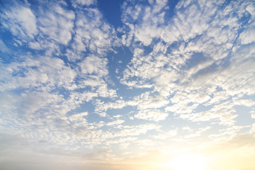 Sunset with sun rays, sky with clouds and sun.