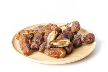 Dried date palm fruit (Deglet Noor) on wooden plate isolated on white background,Ramadan fruit