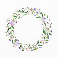 Flowers composition. Wreath made of various flowers and eucalyptus branches on white background. Flat lay, top view