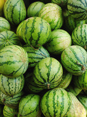 Fototapeta na wymiar Many small watermelons in the open market