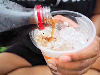 Woman pouring cola drink