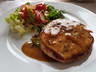 Roasted pork with orange and mustard sauce and salad